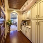 Elegant kitchen in a luxury senior living apartment, showcasing white cabinets and warm wood flooring for a welcoming ambiance.