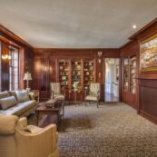 the common areas at The Hearth at Drexel include a library with comfortable seating and a selection of reading material