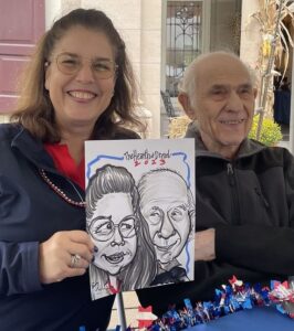 A Hearth at Drexel resident and his daughter holding their caricature drawing