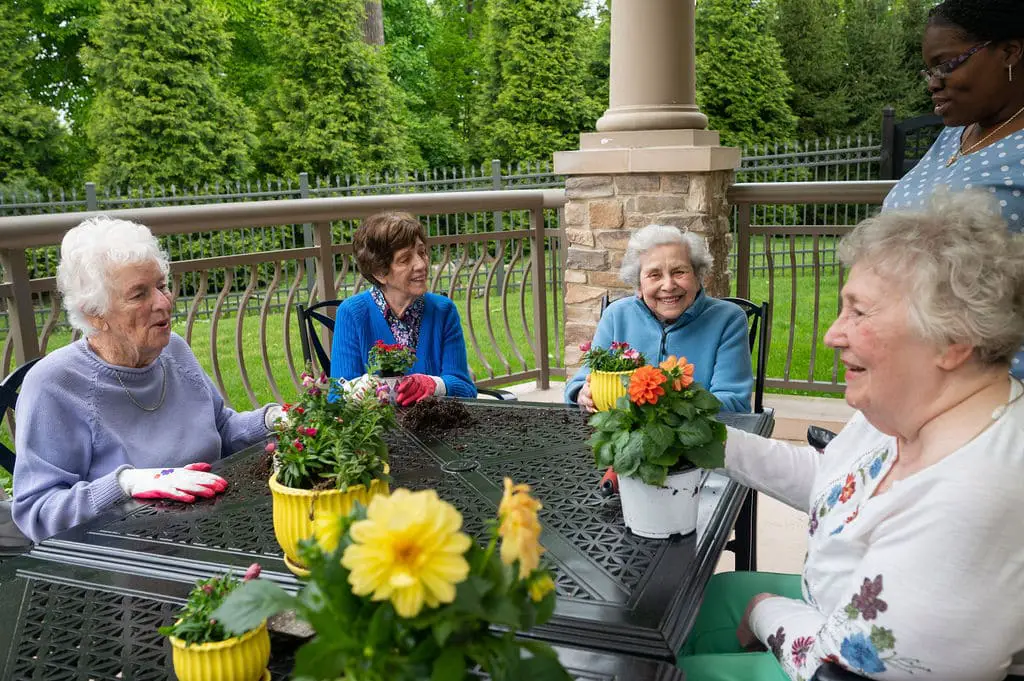 The Hearth at Drexel Residents partake in a gardening activity led by a community life team member.