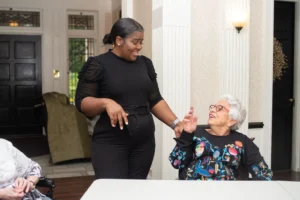 Resident shares a story with a lively team member at The Hearth at Drexel.
